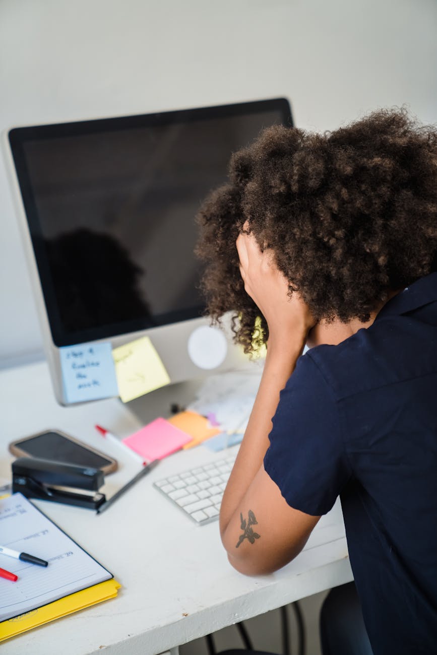 frustrated businesswoman sitting at an office desk