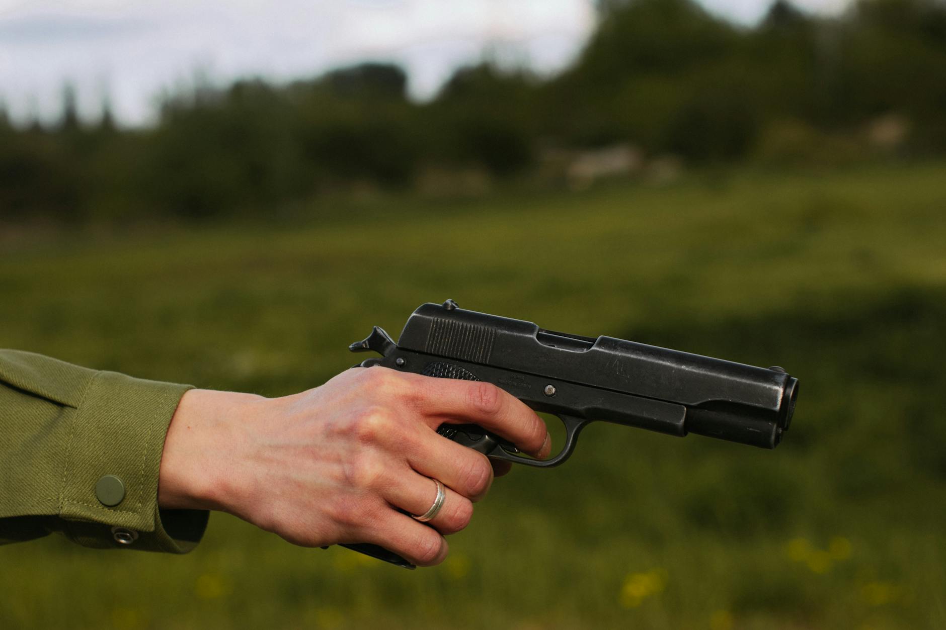 person holding a black hand gun